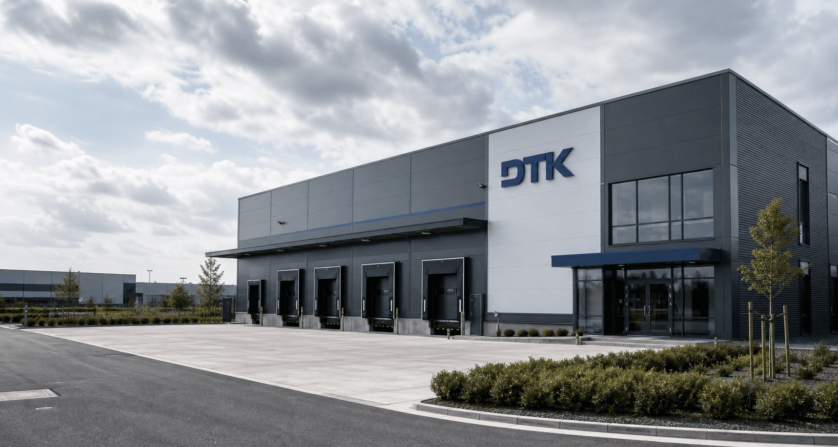 Exterior DTK warehouse building with loading bays and branded facade